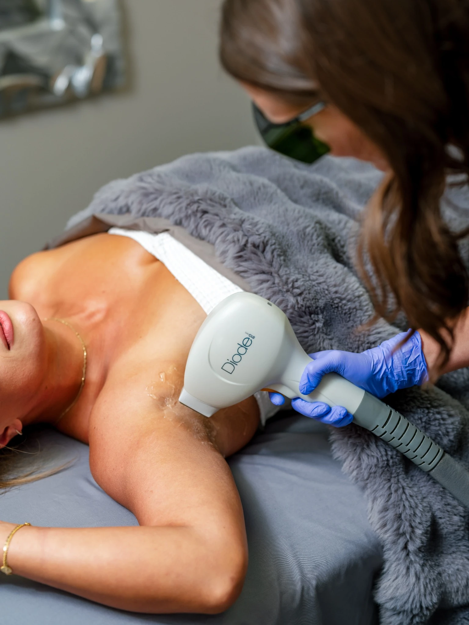 Laser hair removal treatment touch-up session at Tampa Bay Total Wellness using diode laser technology on underarm area