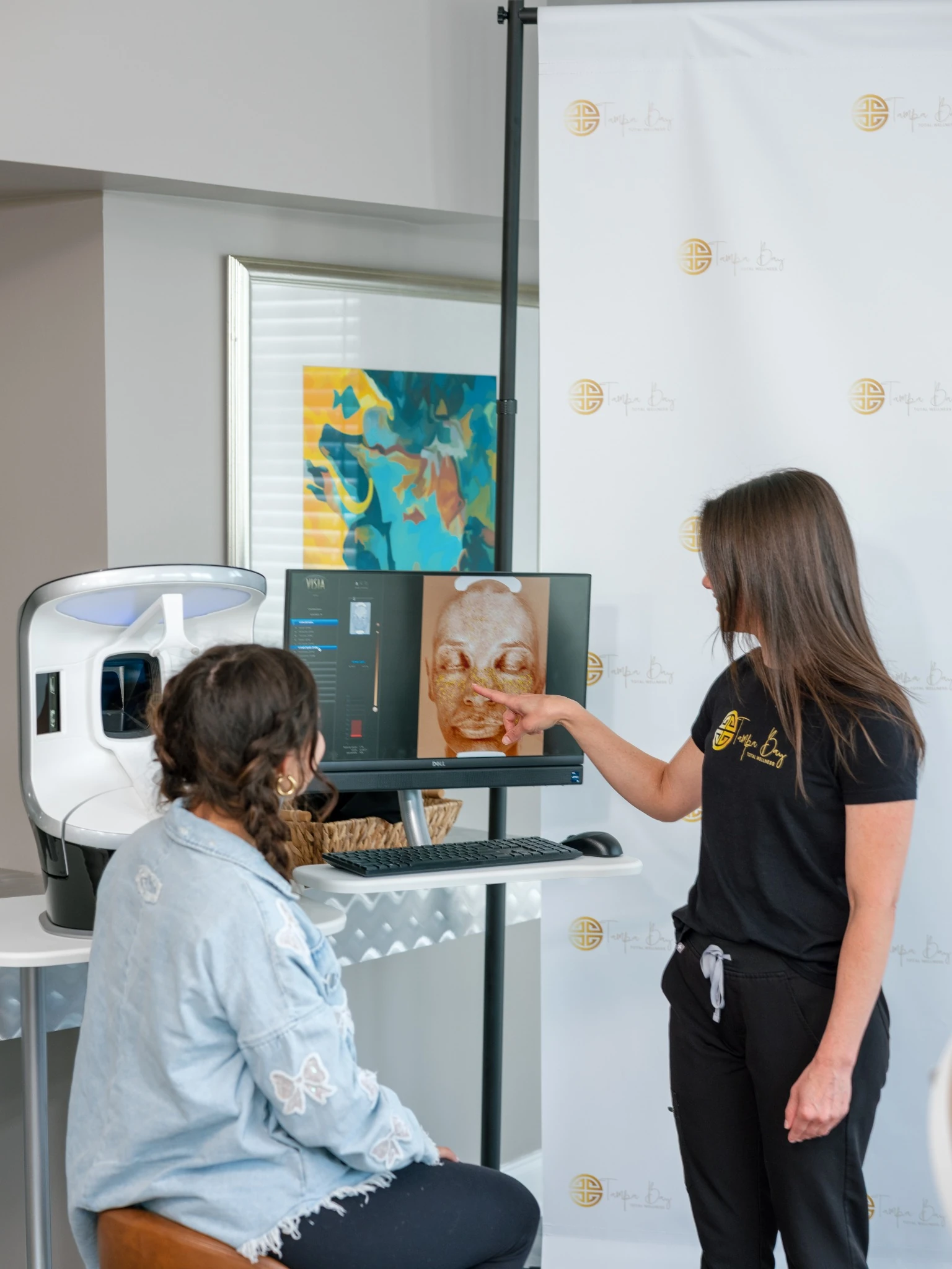 Skin consultation using facial analysis technology at Tampa Bay Total Wellness clinic preparing for summer skincare treatments