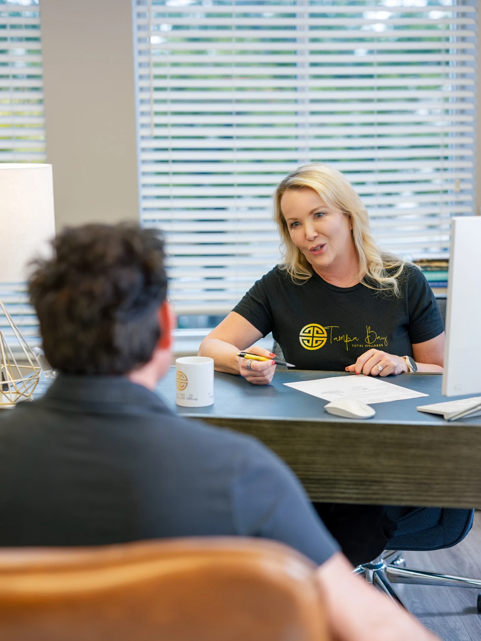 Provider discussing the TRT Membership Program with a patient during a hormone replacement consultation at Tampa Bay Total Wellness