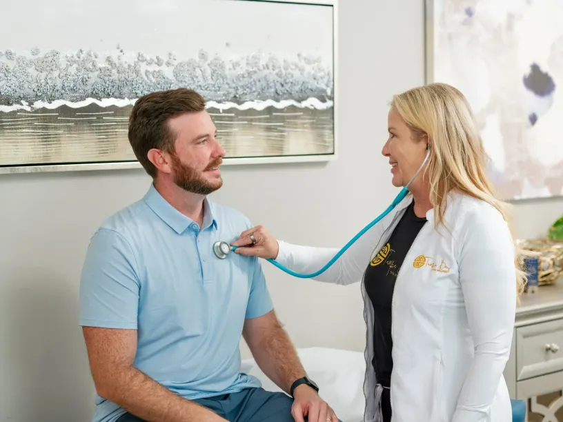 Longevity concierge health consultation at Tampa Bay Total Wellness with provider performing wellness evaluation and patient care