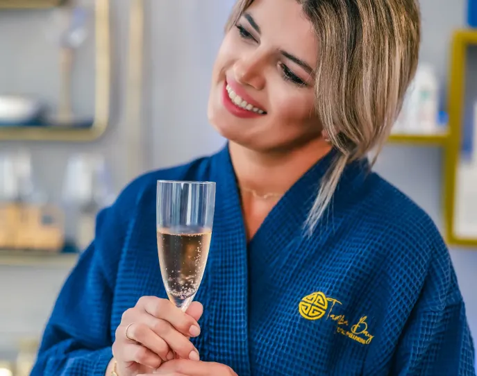 Woman holding a glass of champagne smiling