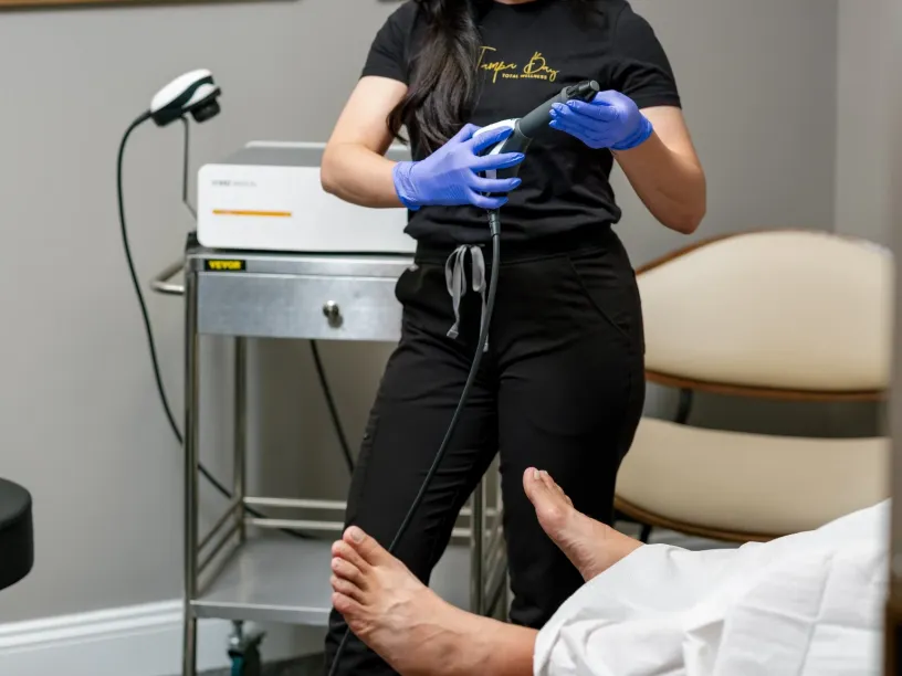 RestoreWave treatment session at Tampa Bay Total Wellness using advanced therapy device for improved circulation and recovery