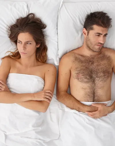 Couple laying in their bed